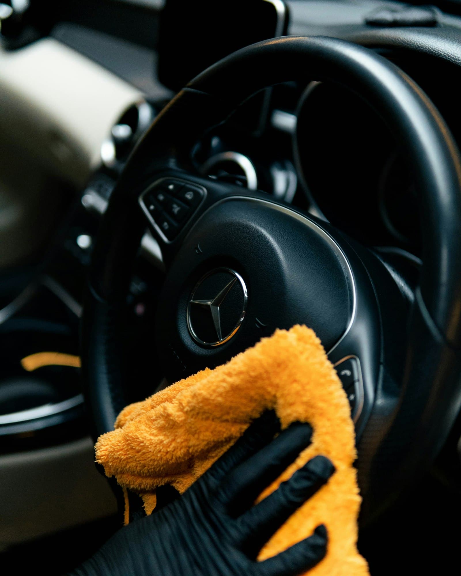 Microfiber towel wiping down a steering wheel